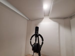 Microphone and headset in a white recording room