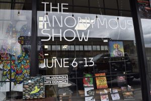 Front window of Myth Valley Studio featuring The Anonymous show June 6 to 13th